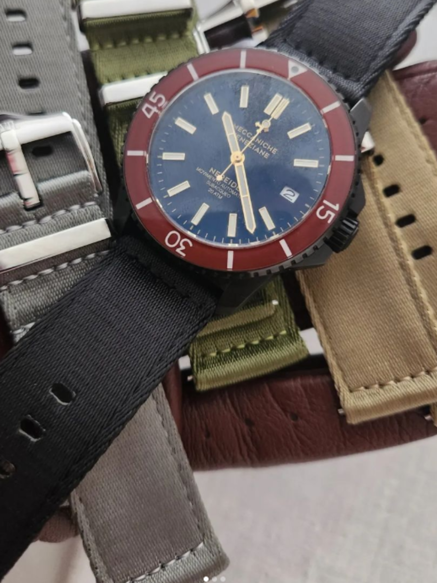 Multiple straps arranged beneath a diver watch