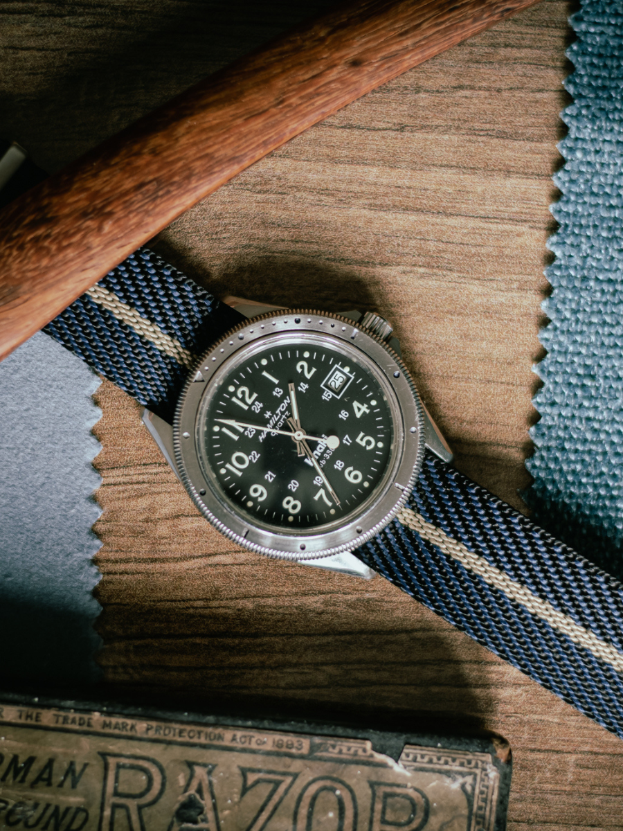 Striped fabric strap styled with a field watch
